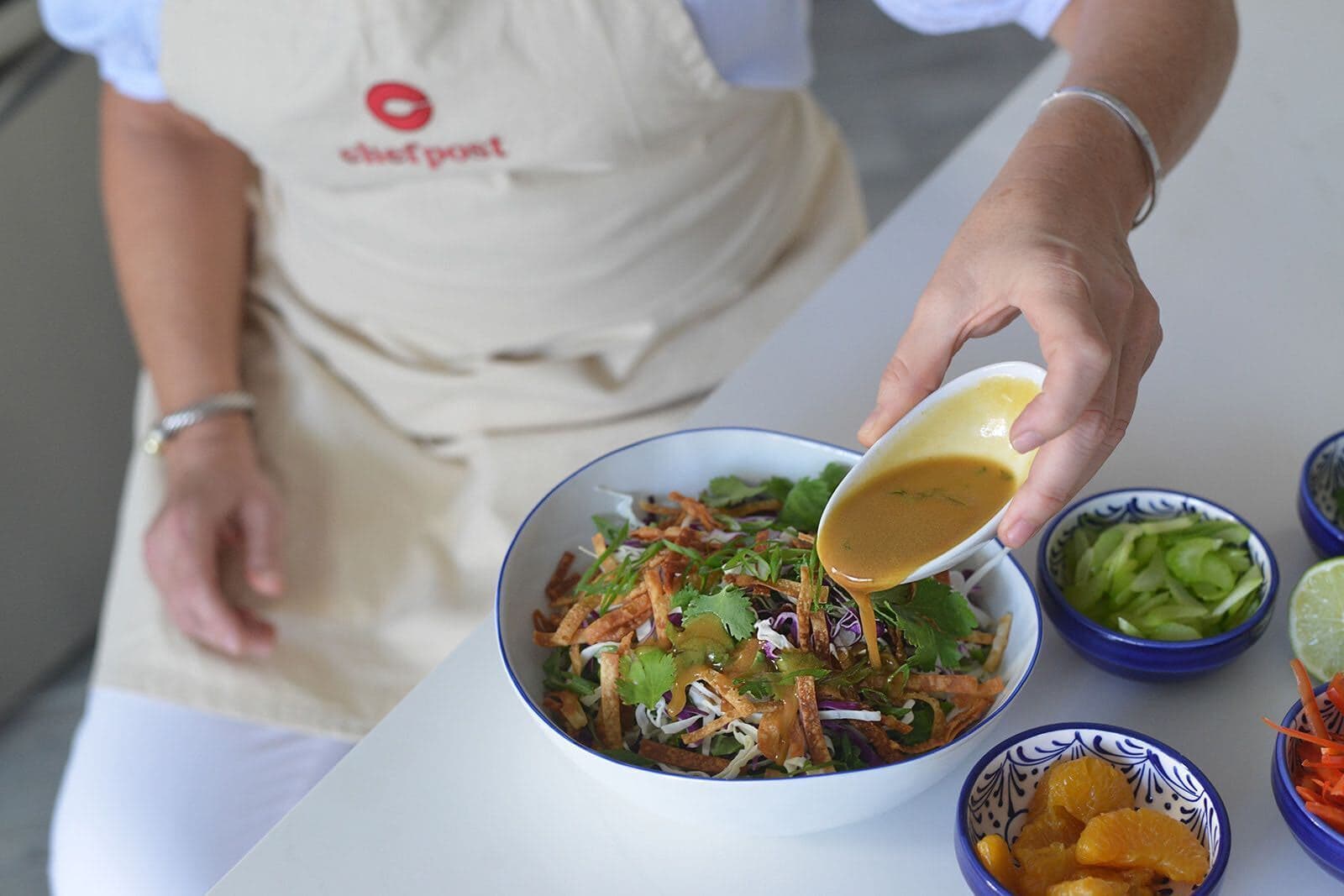 A Chefpost private chef plating a healthy weekly meal-prep dish in a Boca Raton kitchen