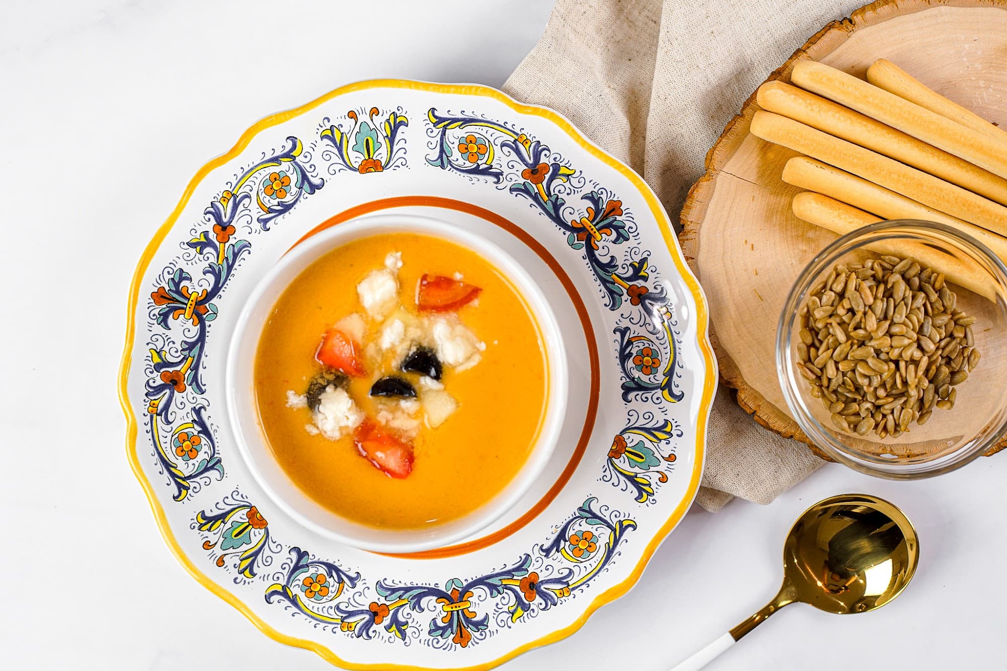 A chilled gazpacho garnished in a painted bowl by a private chef in Sunny Isles
