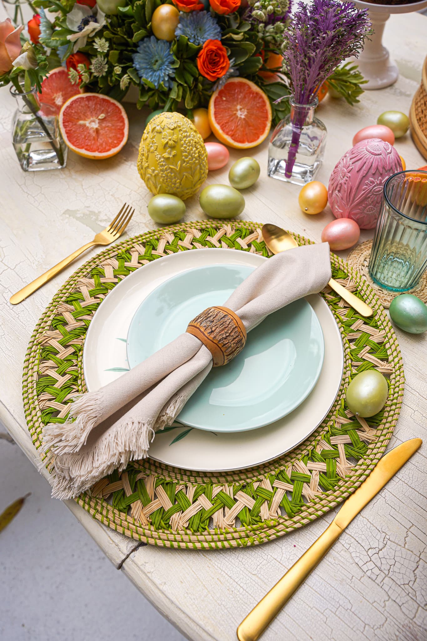 A colorful spring tablescape with flowers and citrus set by a private chef in South Beach
