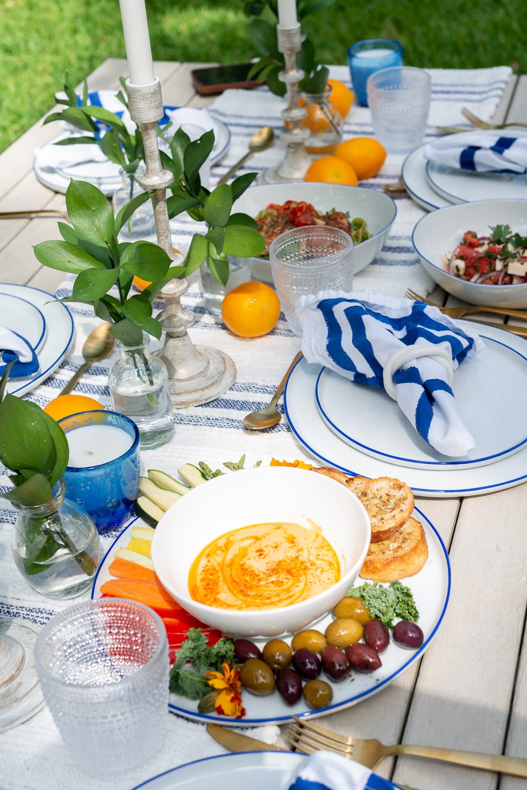 An outdoor Mediterranean table with lemons and small plates set for a dinner in Coconut Grove
