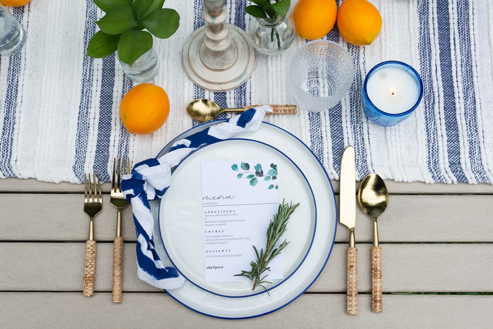 An elegant coastal place setting with gold flatware and lemons by a private chef on Long Island