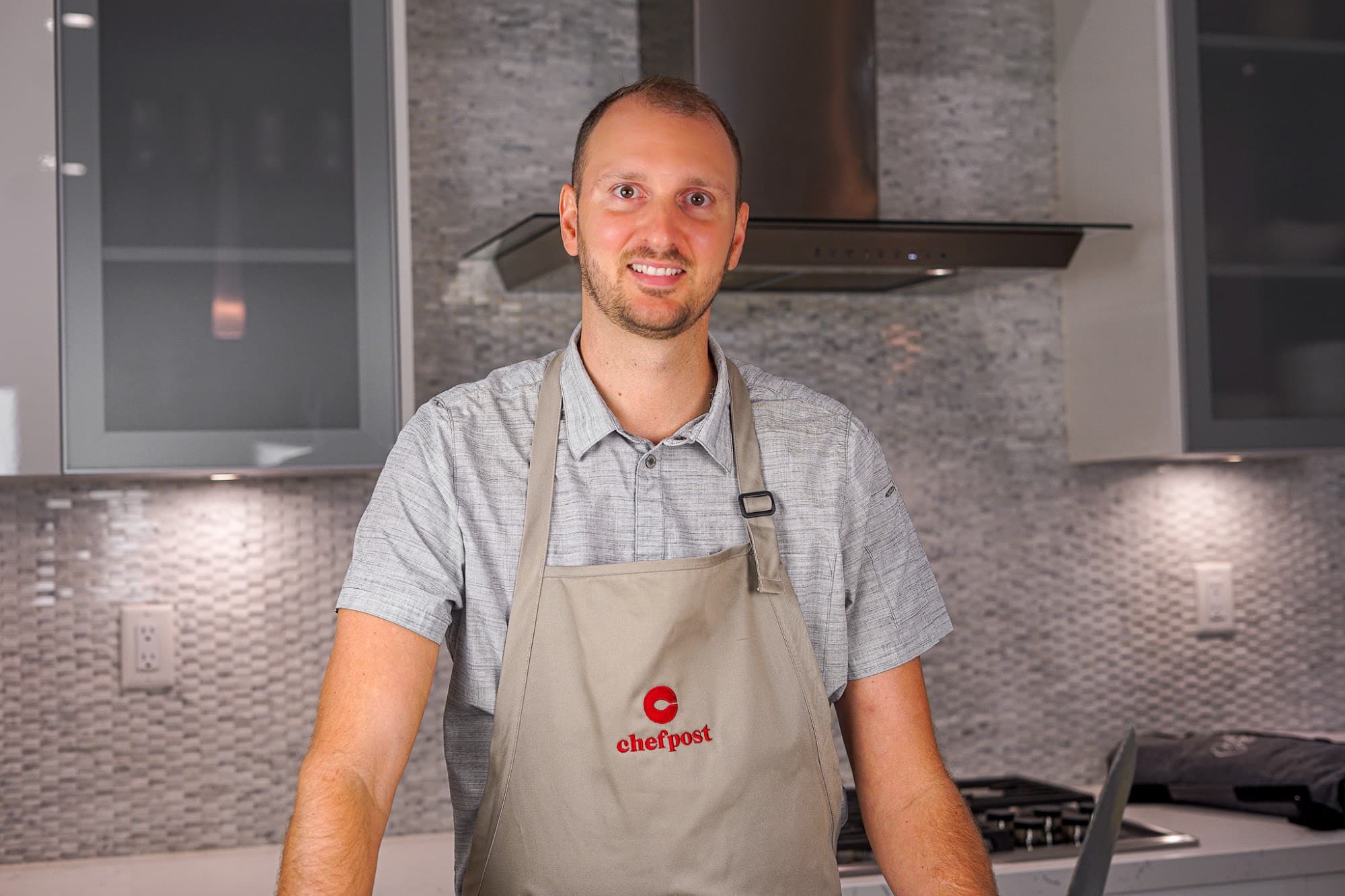 A Chefpost chef in an apron in a home kitchen