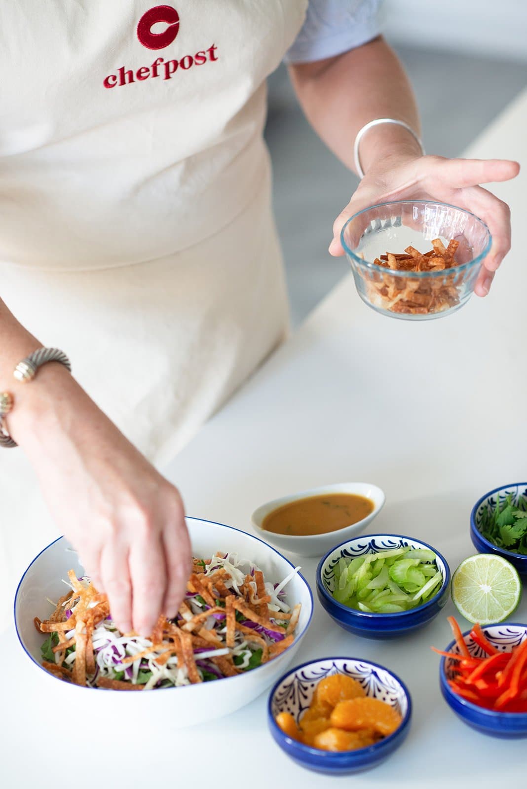 A Chefpost chef assembling a fresh, special-diet bowl in a home kitchen