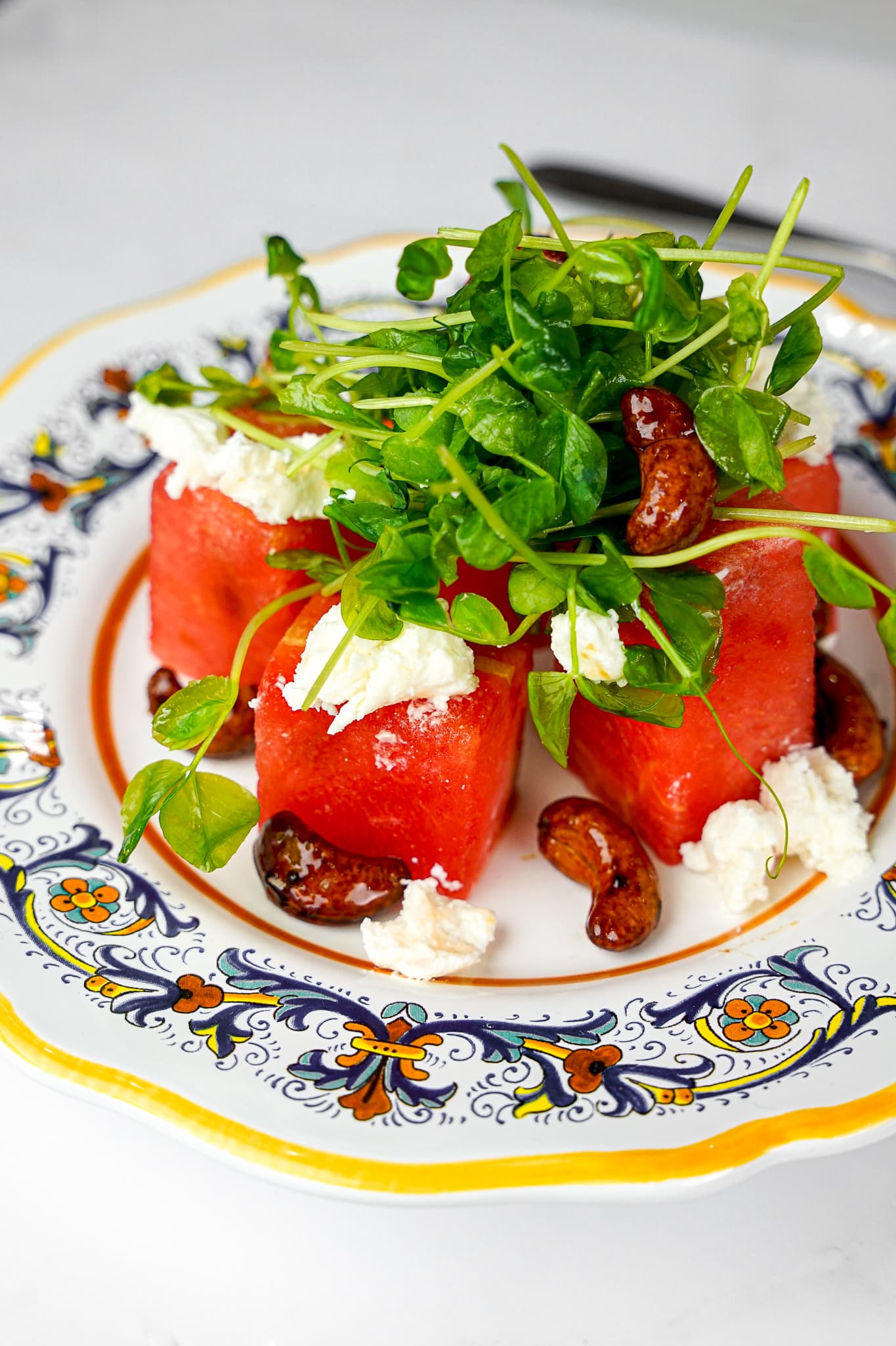 A watermelon, feta, and arugula salad plated by a private chef for a South Beach dinner