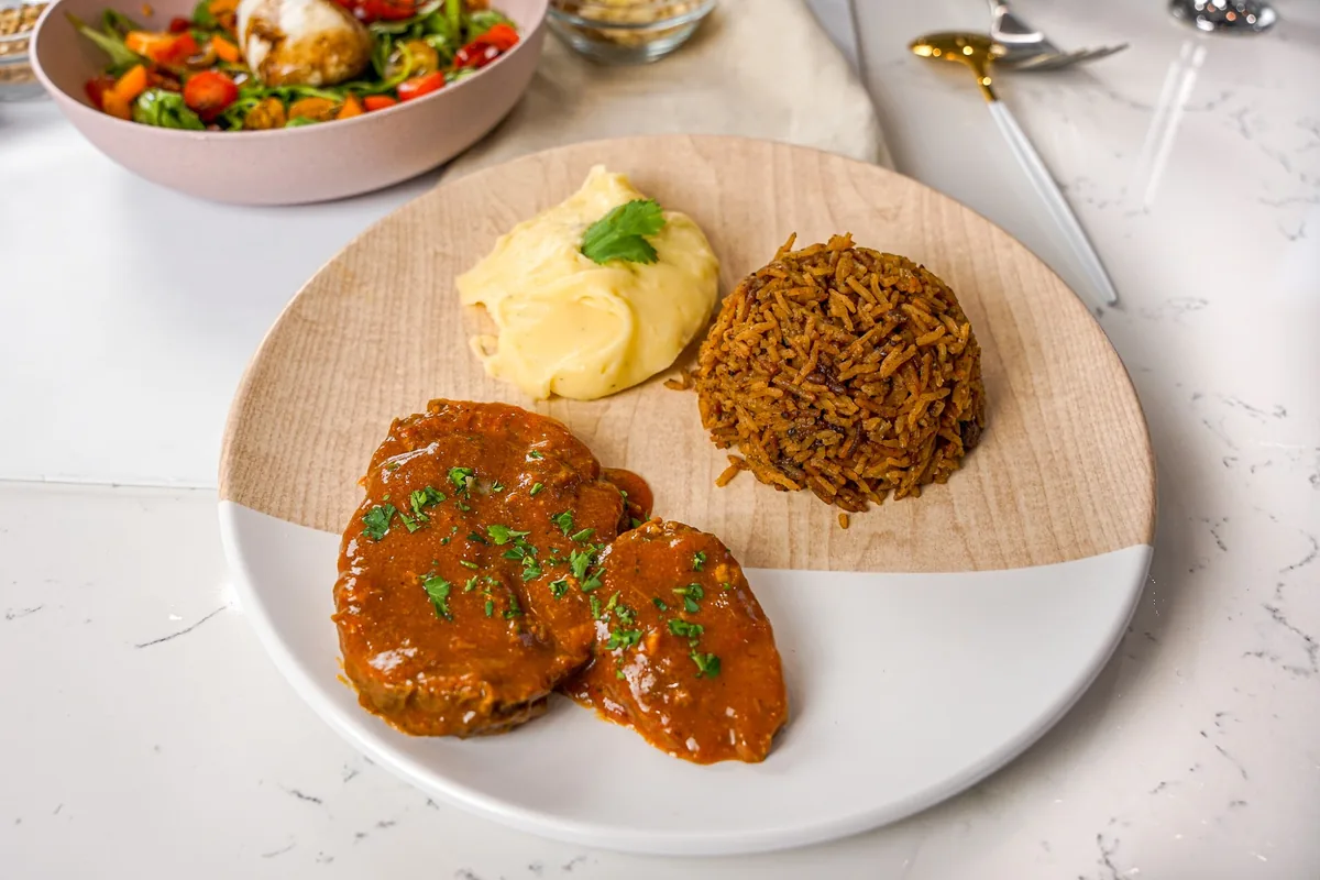 A plated weeknight dinner of steak, mashed potato, and rice from a private chef in Atlanta